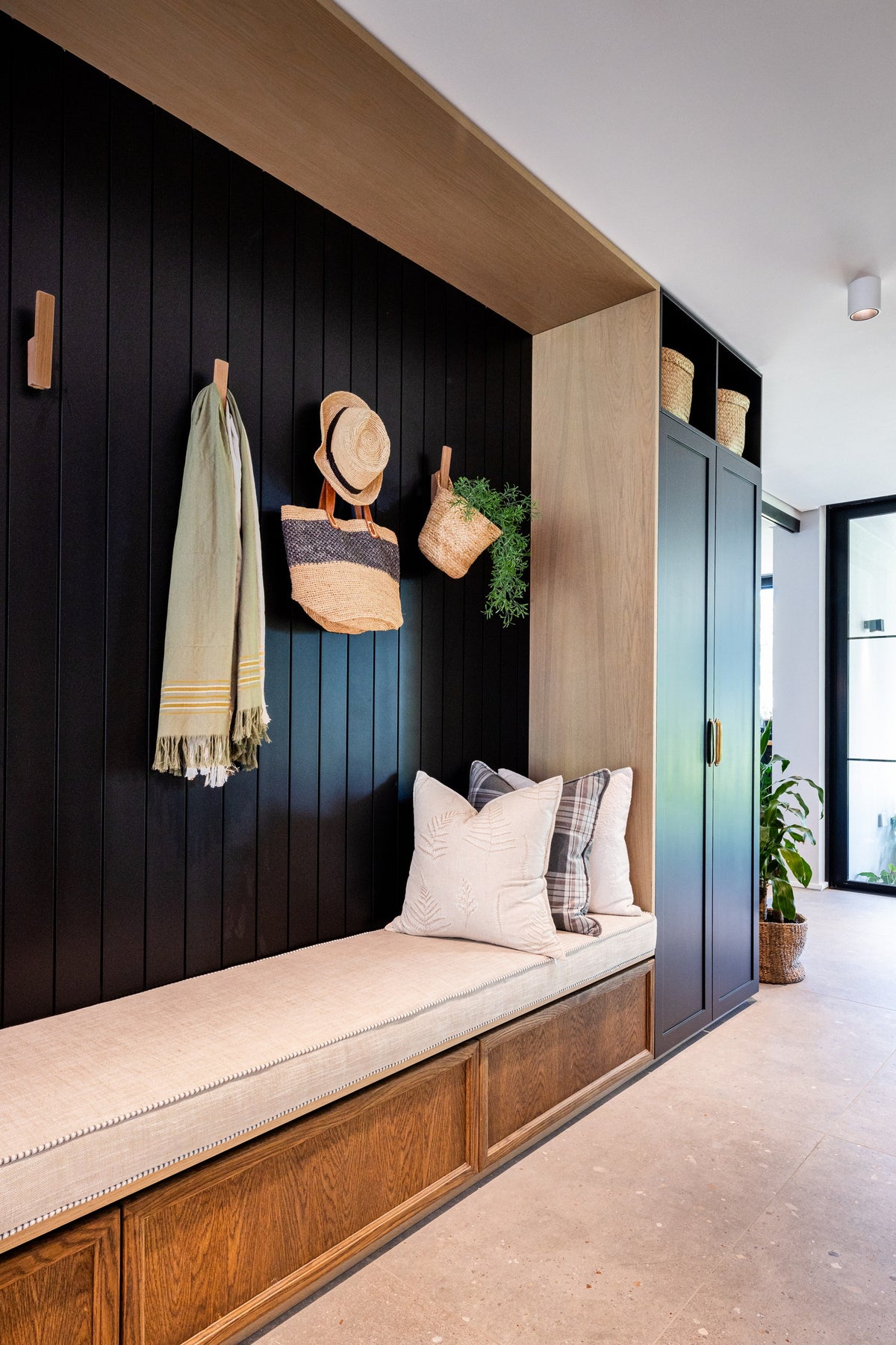 Duvenci Interiors — Timber entrance bench with soft cushions