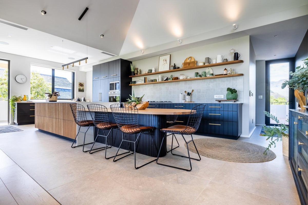 Duvenci kitchen and dining room with warm timber and dark cabinetry