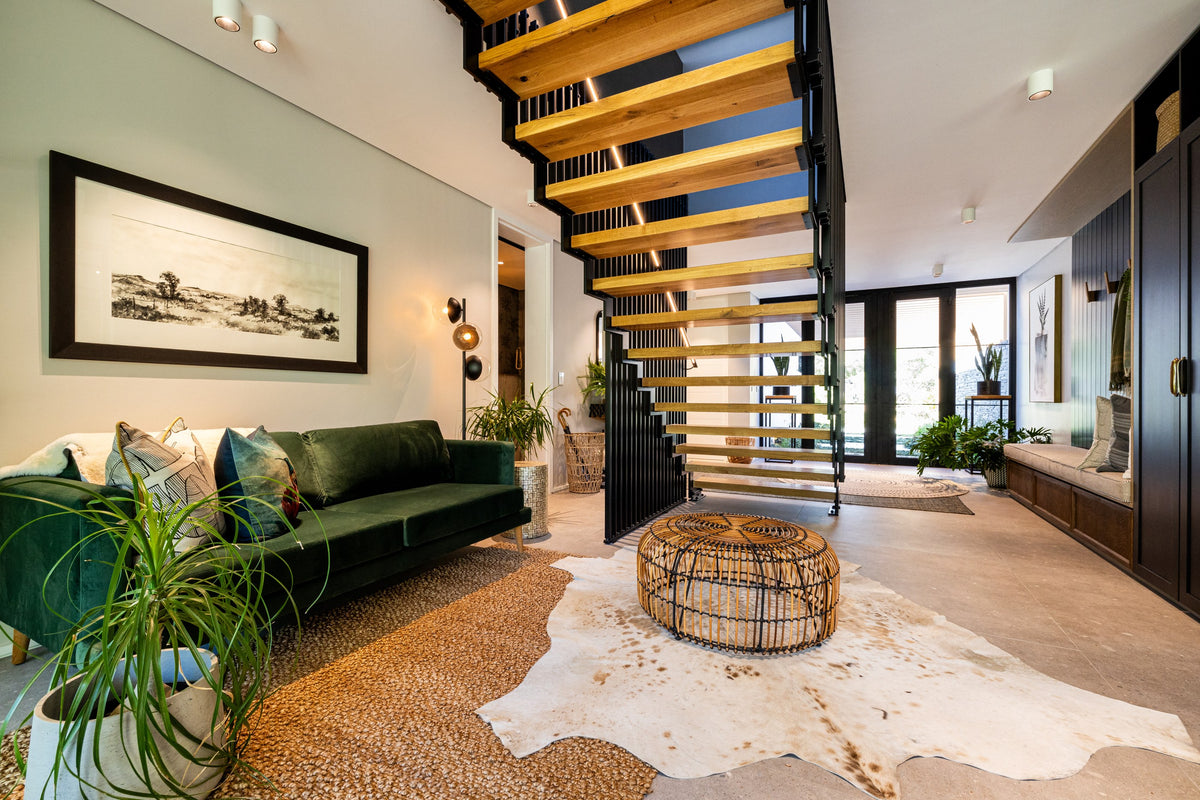 Duvenci Interiors — Timber staircase and green sofa