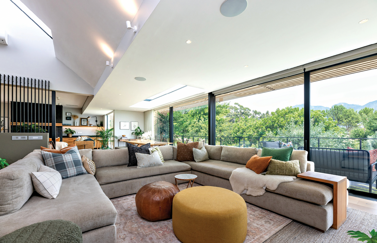 Duvenci living room with layered textiles and mountain views. Photography: Malitza de Kock.