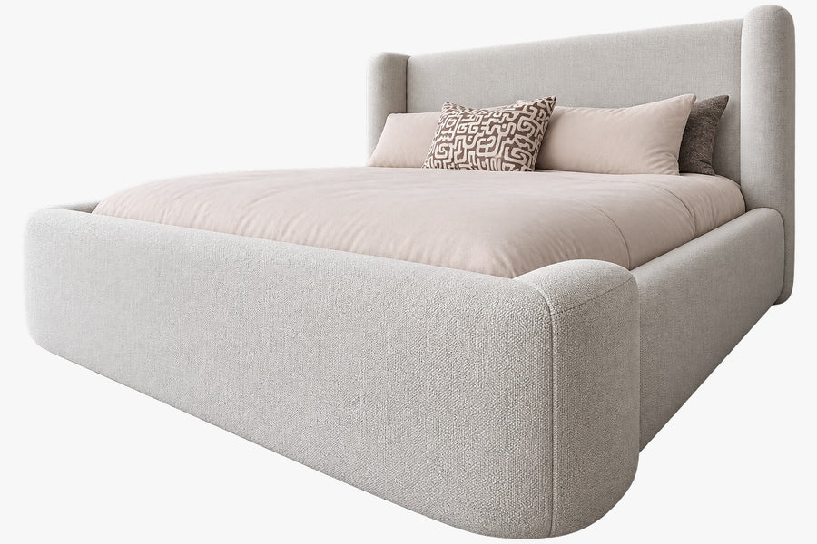 Upholstered bed with winged headboard, designed and manufactured by Duvenci Interiors